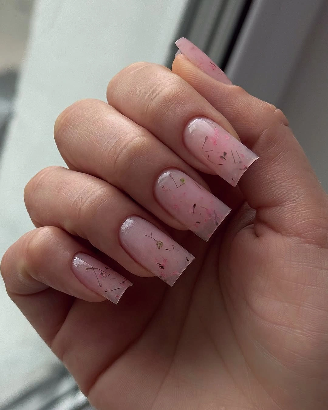 long translucent pink nails with delicate marbled lines
