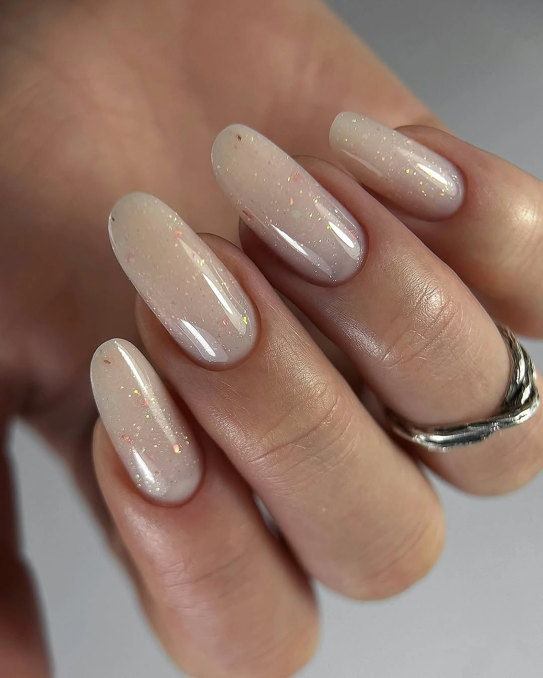 sheer nude nails with a soft pearl-like shimmer