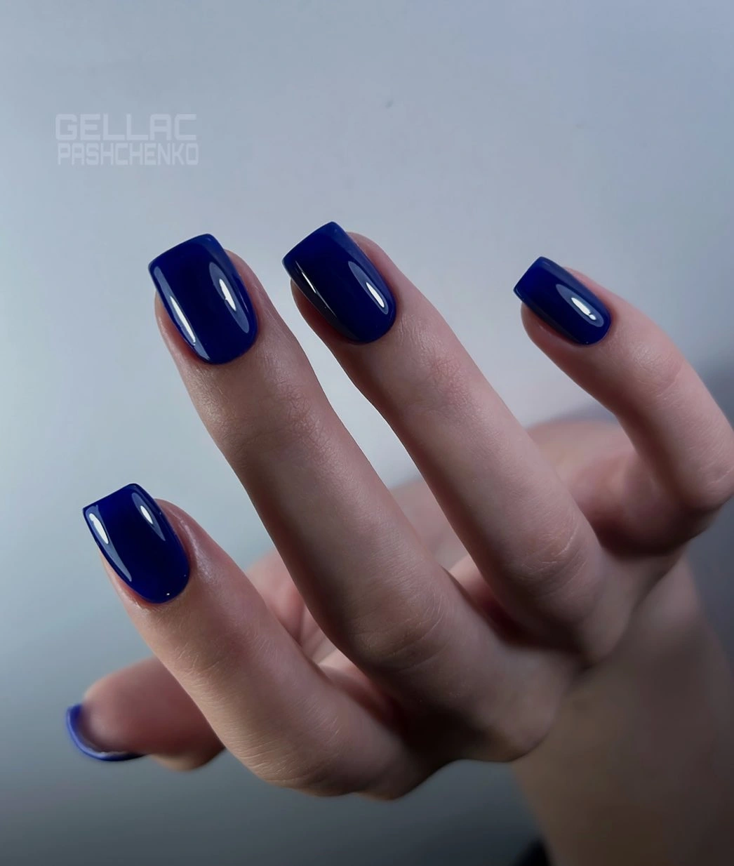 Glossy deep navy medium square nails with clean edges
