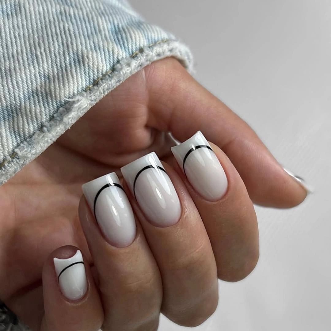 Short white square nails with delicate black outline details