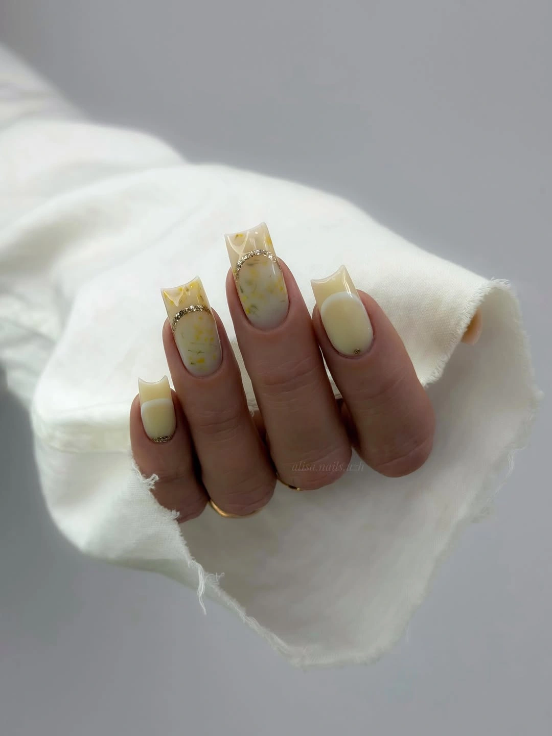 buttercream square nails with gold arcs