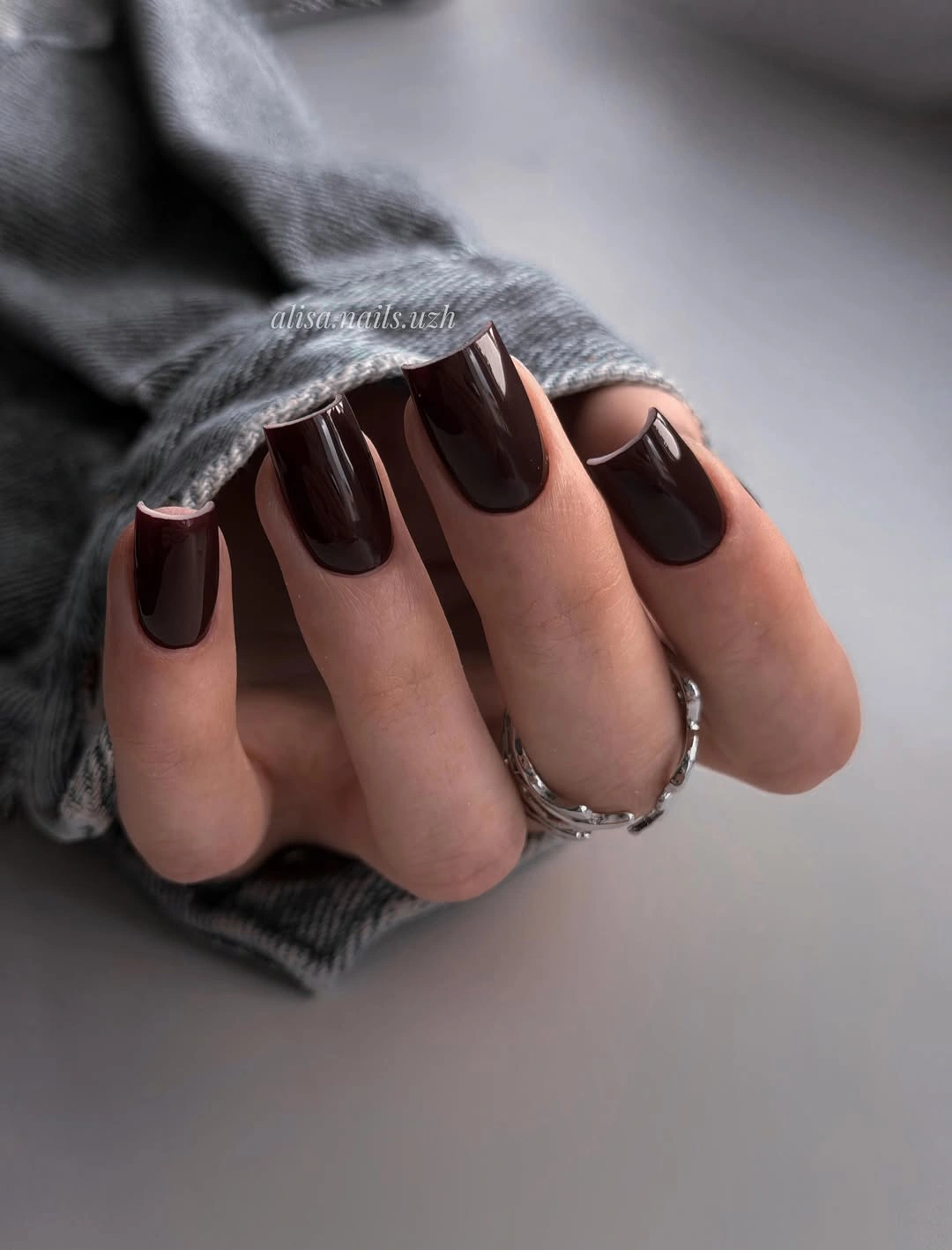 dark burgundy square nails with pale curves