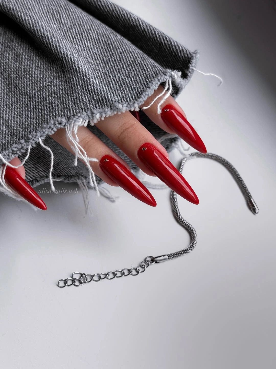 long glossy cherry red stiletto manicure