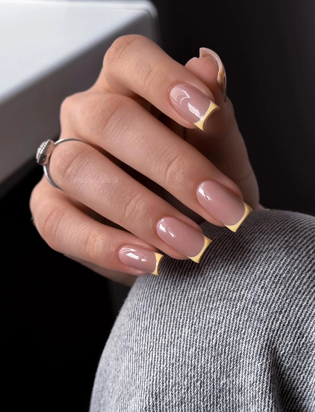 buttery yellow French tips on nude nails