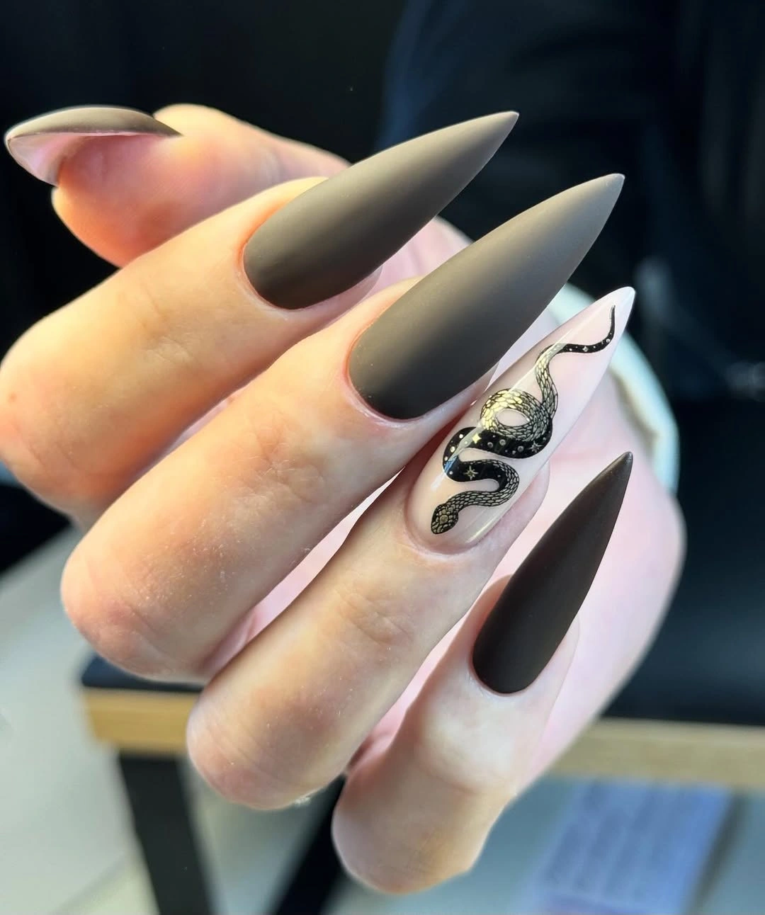 dark stiletto nails with snake accent