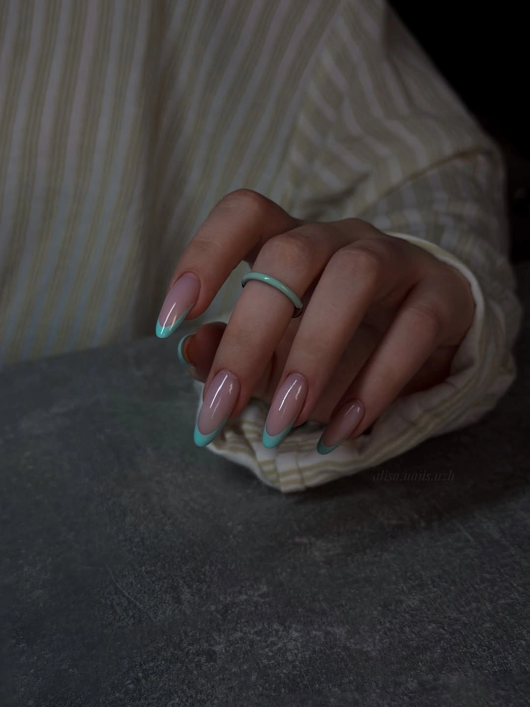 turquoise French tips on sheer almond nails