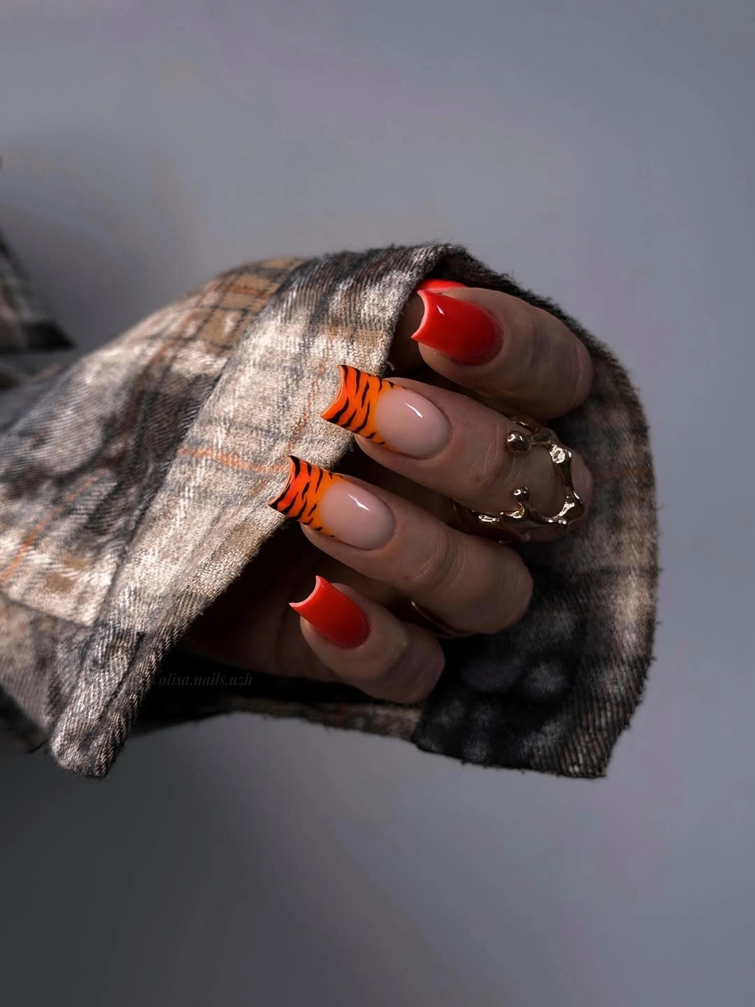 red orange square nails with tiger stripe tips