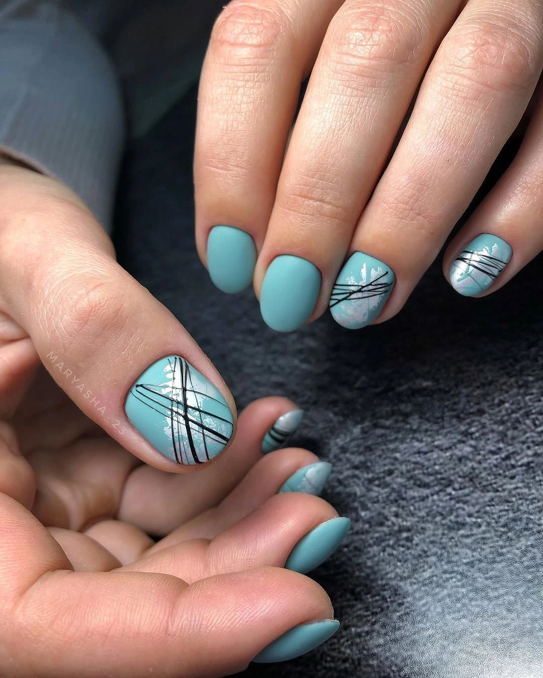 Matte turquoise short nails with silver graphic accents
