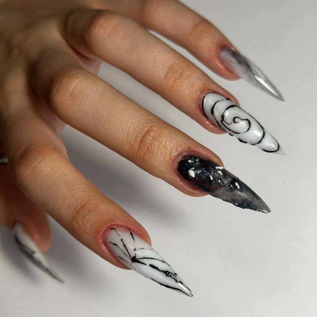 Long black and white stiletto nails with graphic linework