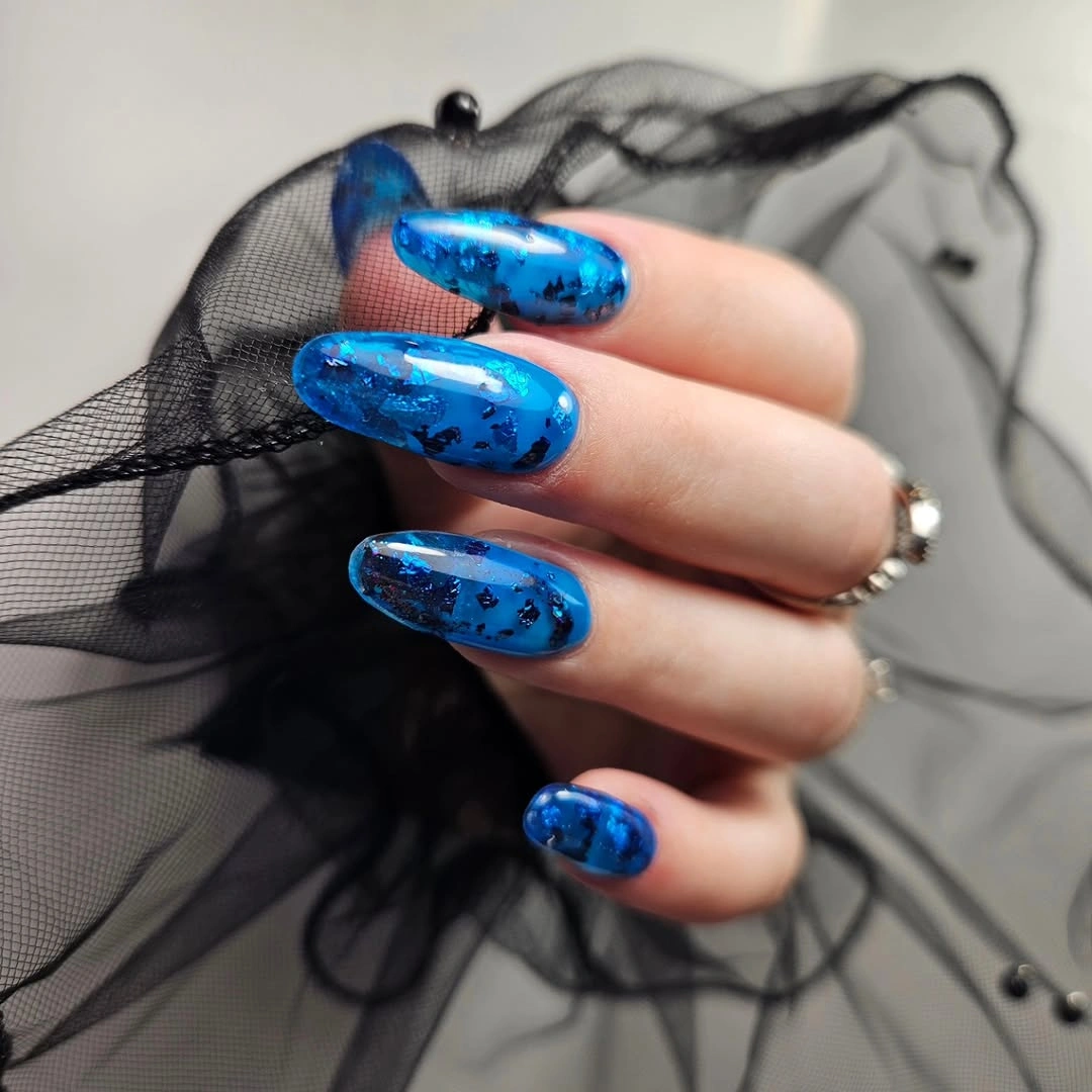Medium blue square nails with darker layered accents