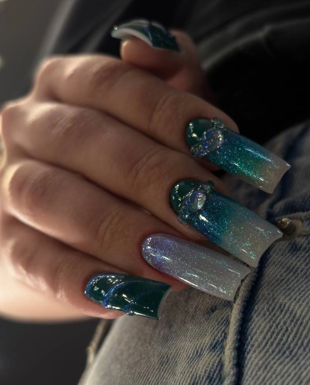 Long square nails with translucent teal blue and silver sparkle