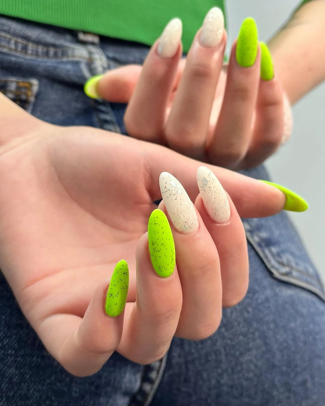 Neon chartreuse almond nails with speckled cream accents