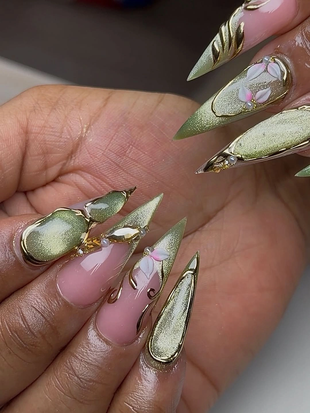 pink olive almond nails with white flowers and gold accents