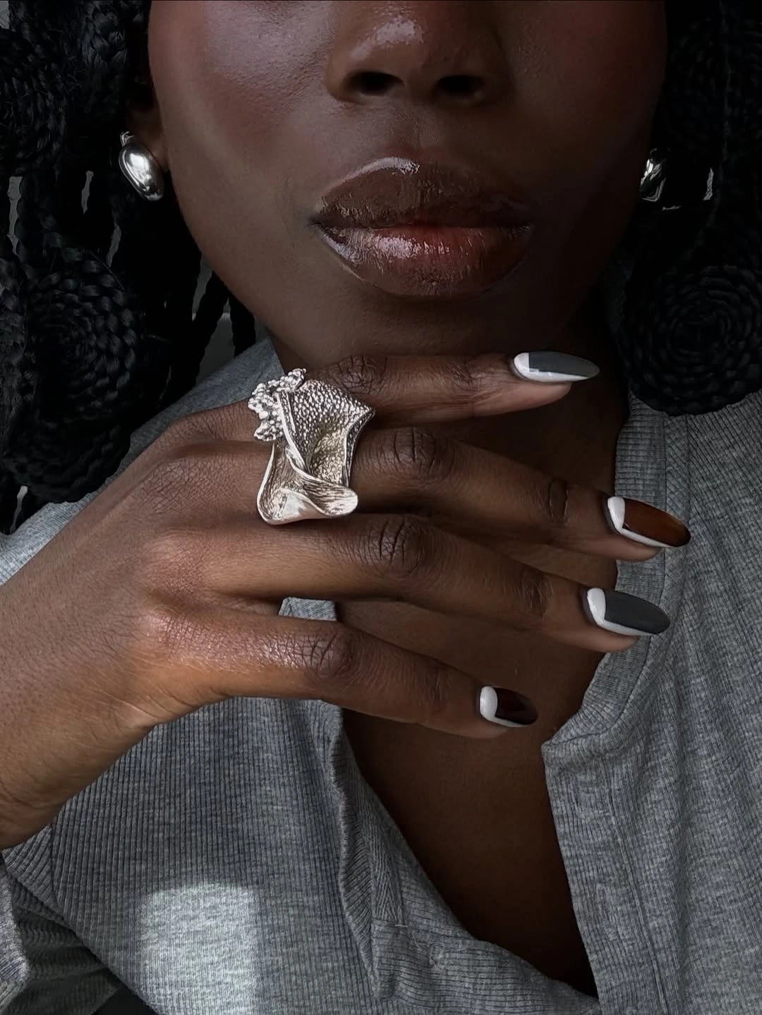 pale neutral almond nails with statement silver ring