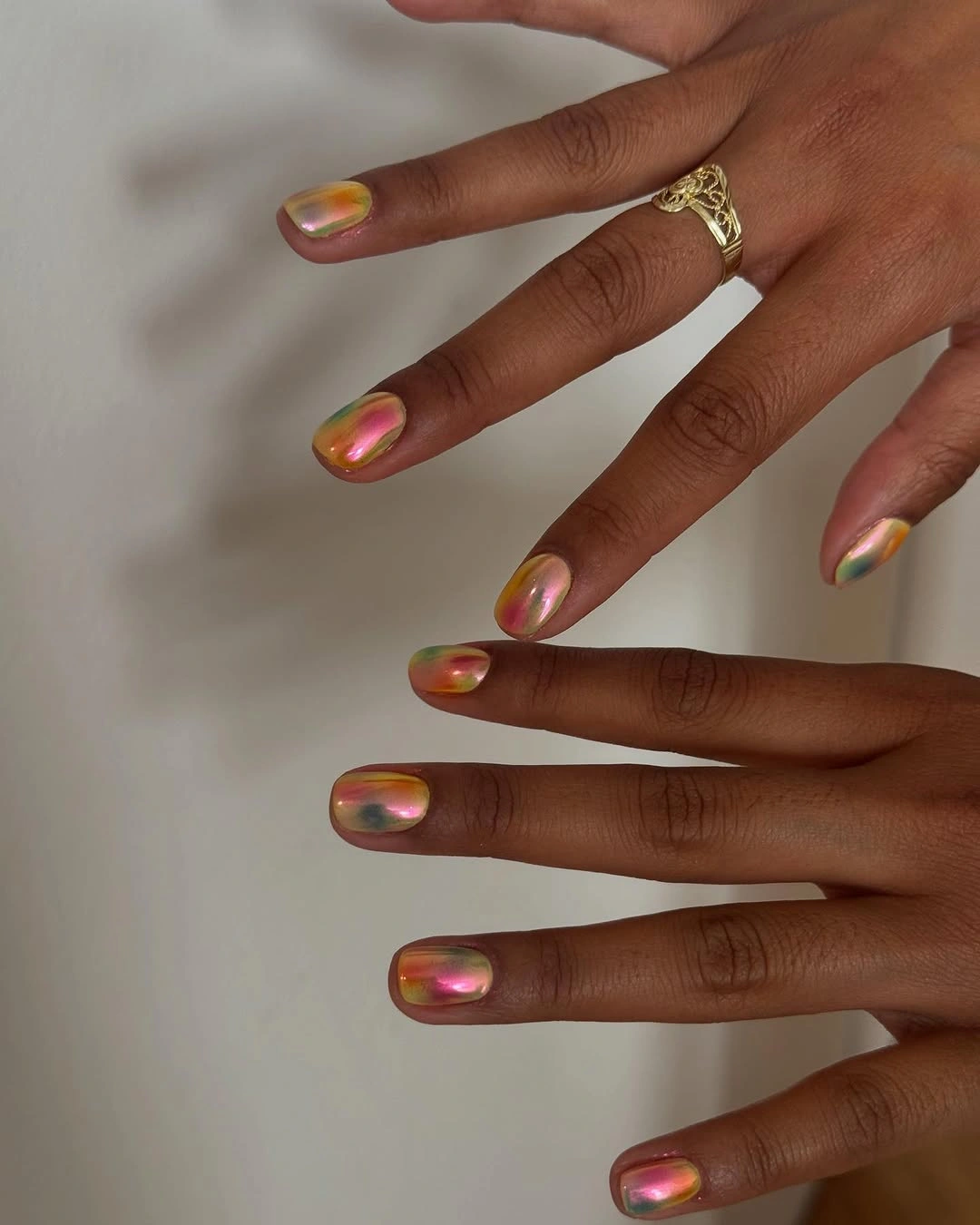 long slender nails with orange copper and pink iridescent tips