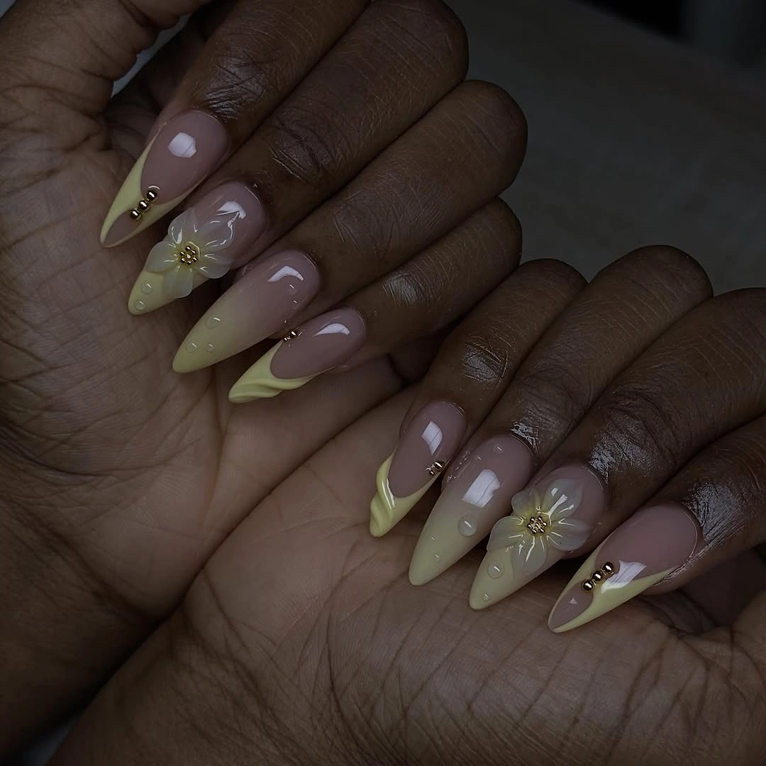 long lilac almond nails with yellow tips and gold accents