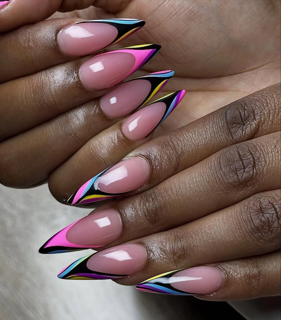 pink stiletto nails with black blue green and yellow outlines