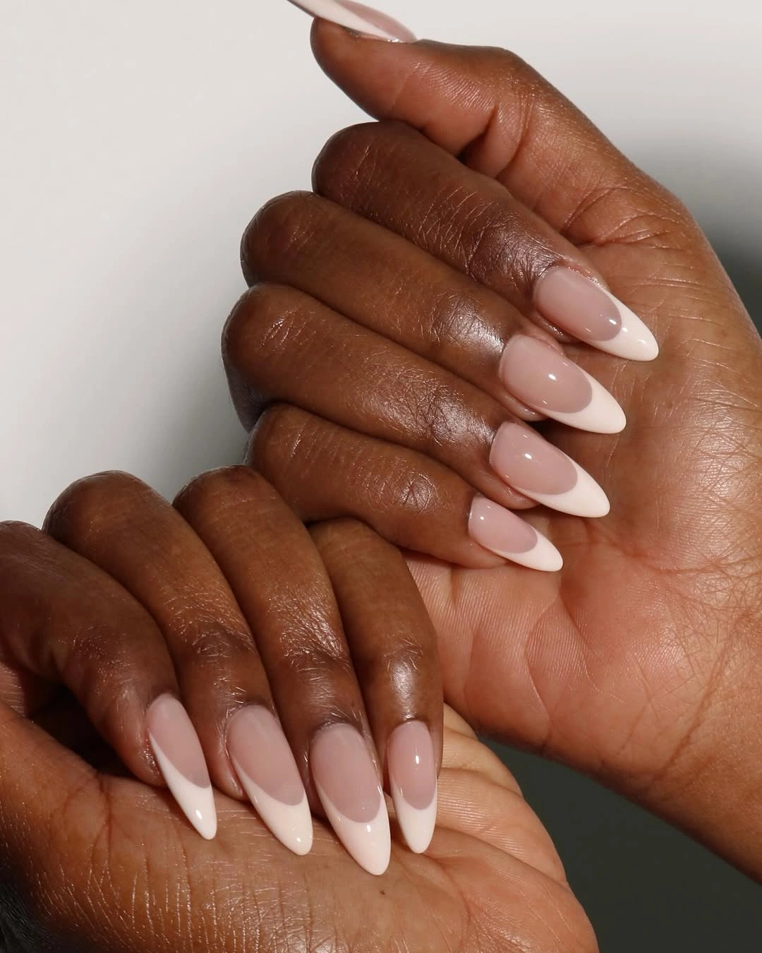 Long almond nails with a smooth milky nude pink finish