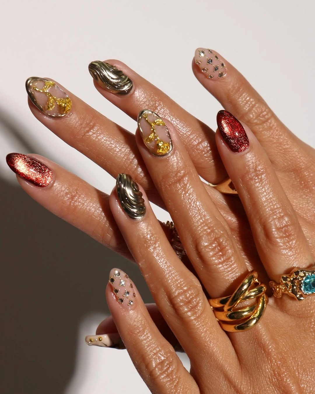 Long nails with mixed gold silver bronze red and black accents