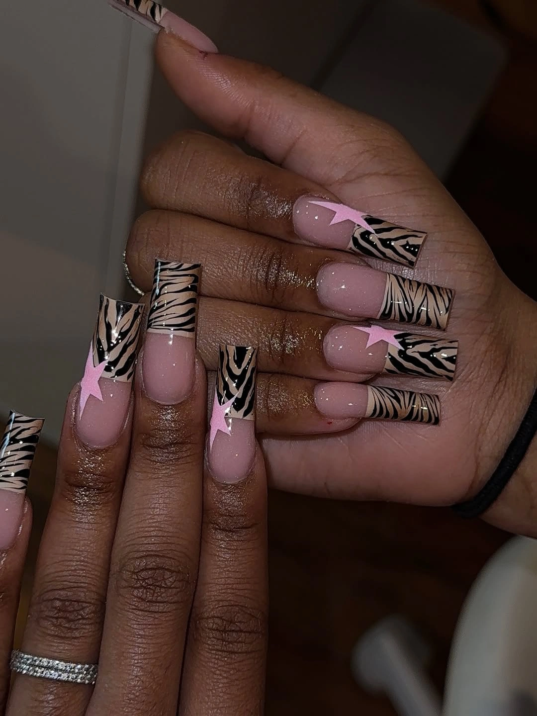 Long pink tapered nails with black and white linear accents
