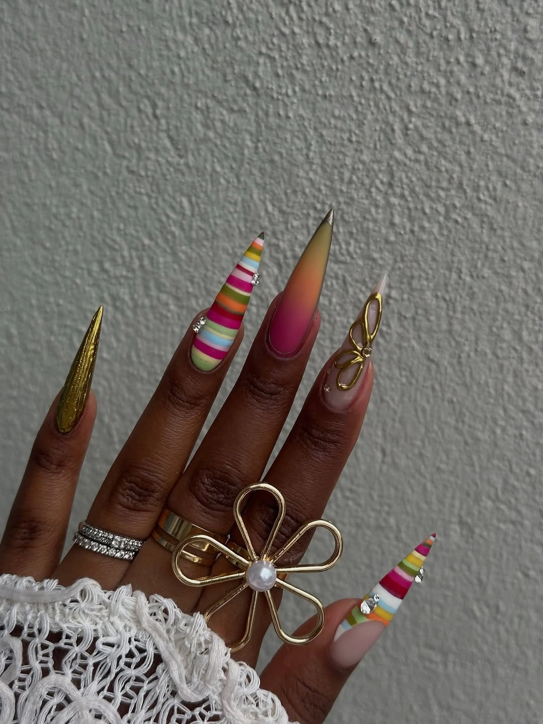 Long stiletto nails with narrow rainbow tip bands