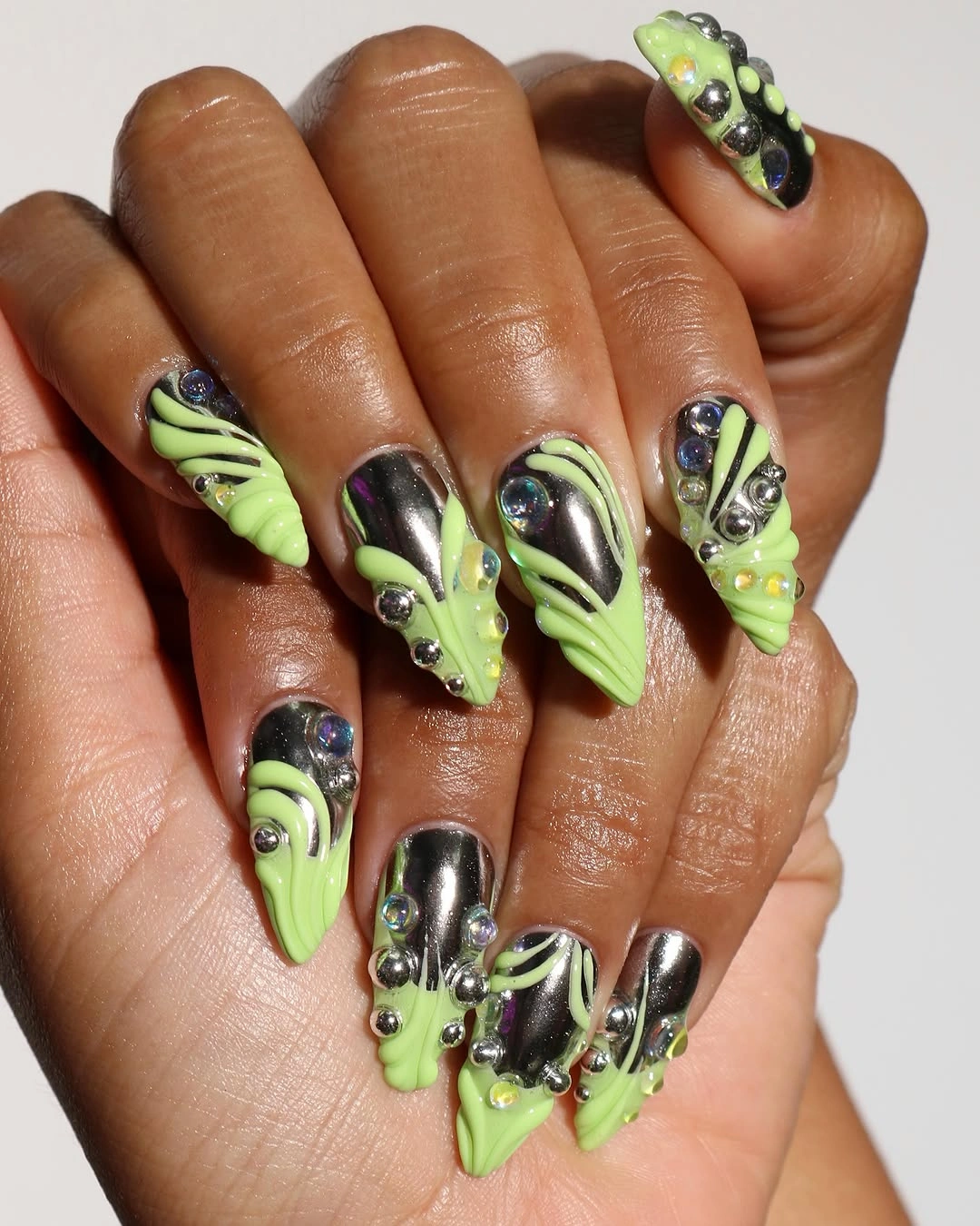 Long lime green and black stiletto nails with graphic accents