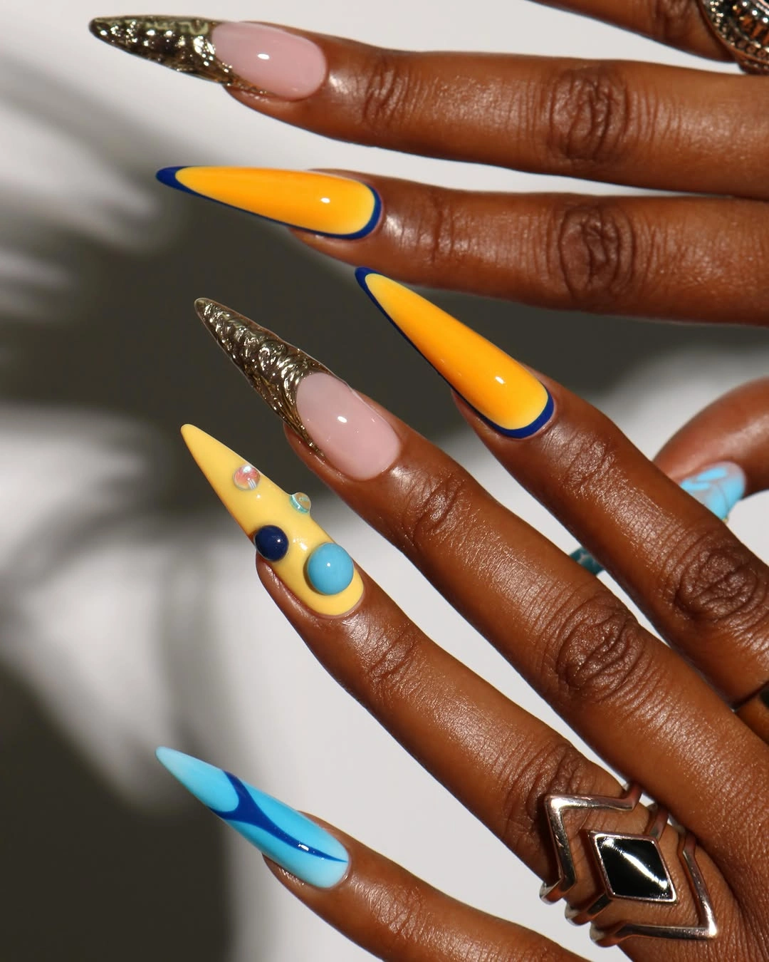 Orange cobalt and turquoise stiletto nails with graphic blocks