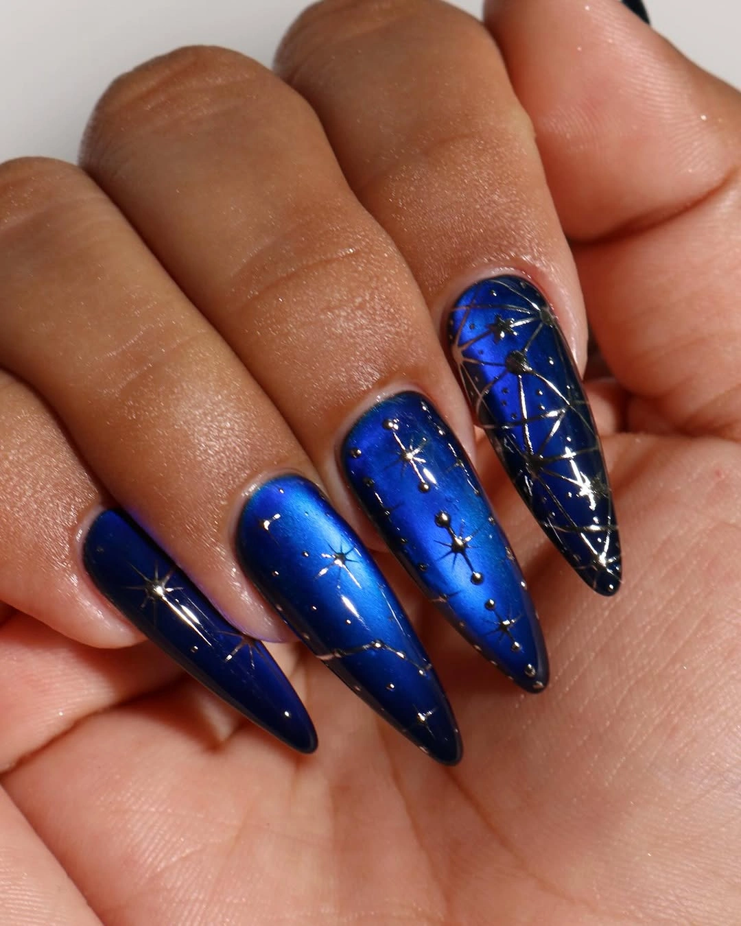 Long cobalt blue stiletto nails with fine pale line details