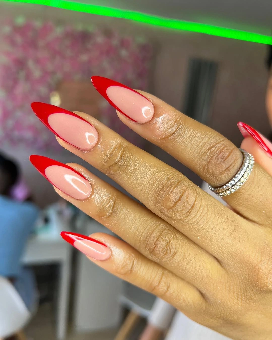 Red outlined stiletto nails with sheer pink centers