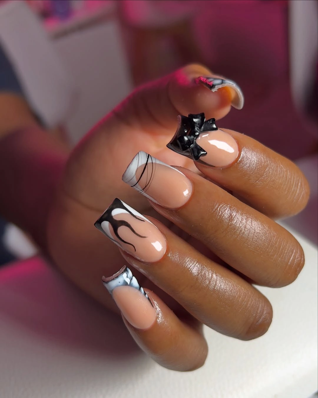Black and white graphic square nails with bow accent