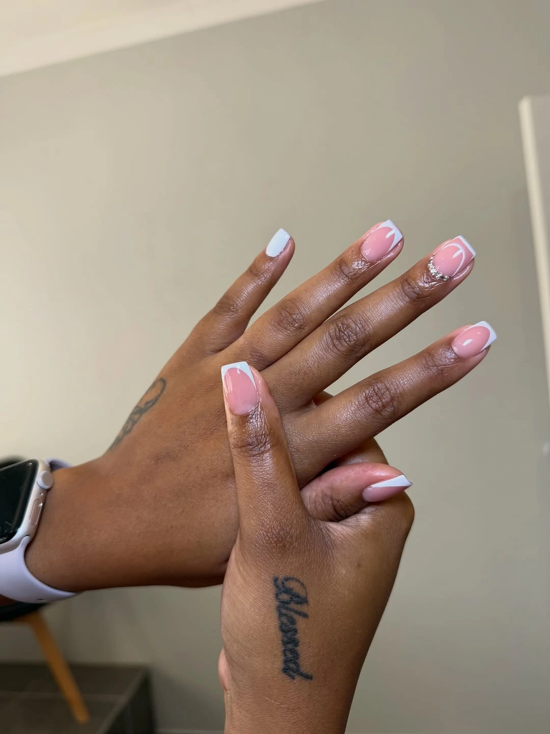 Pink and white square French nails with curved swoops