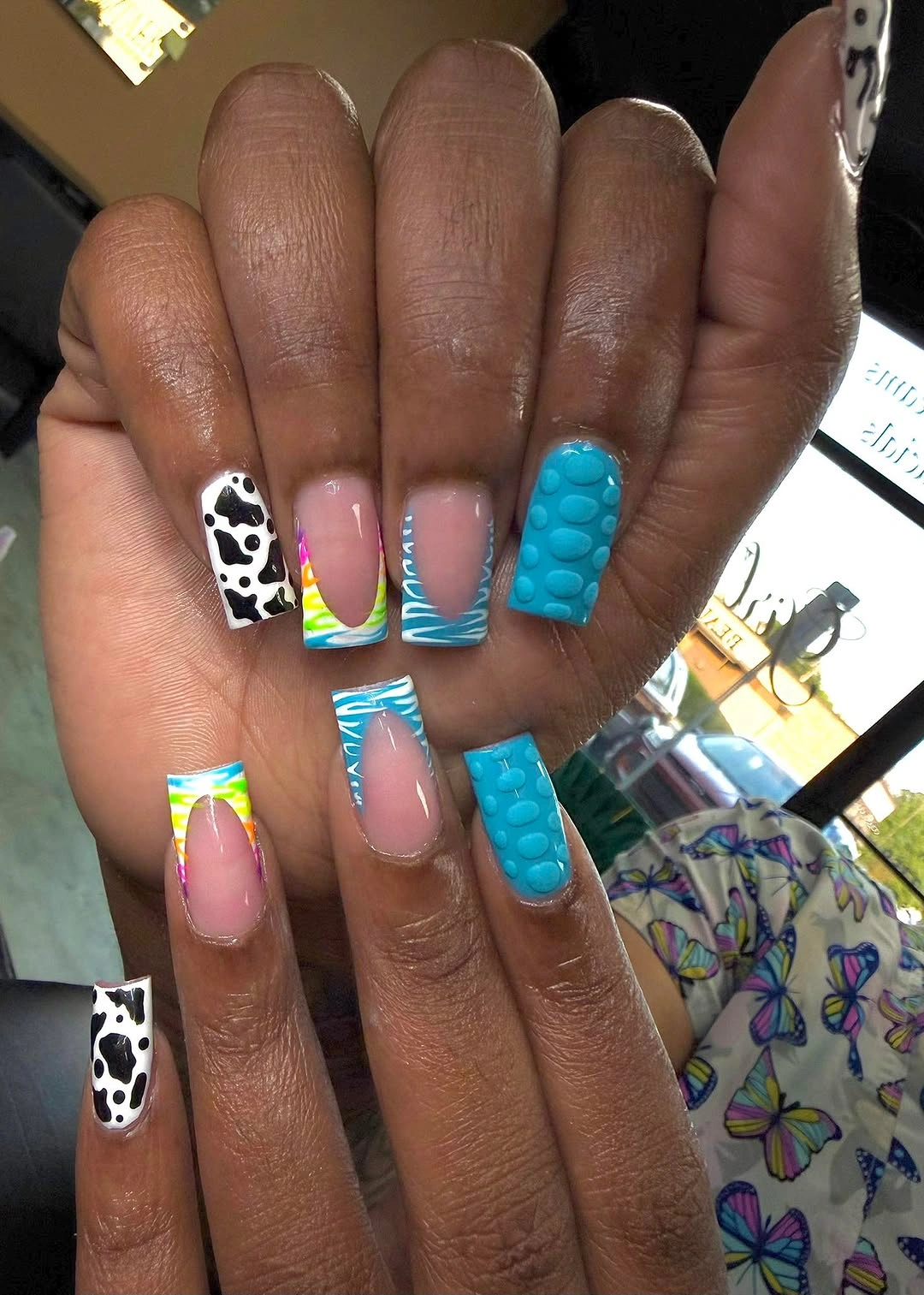 Turquoise cow print square nails with raised dots
