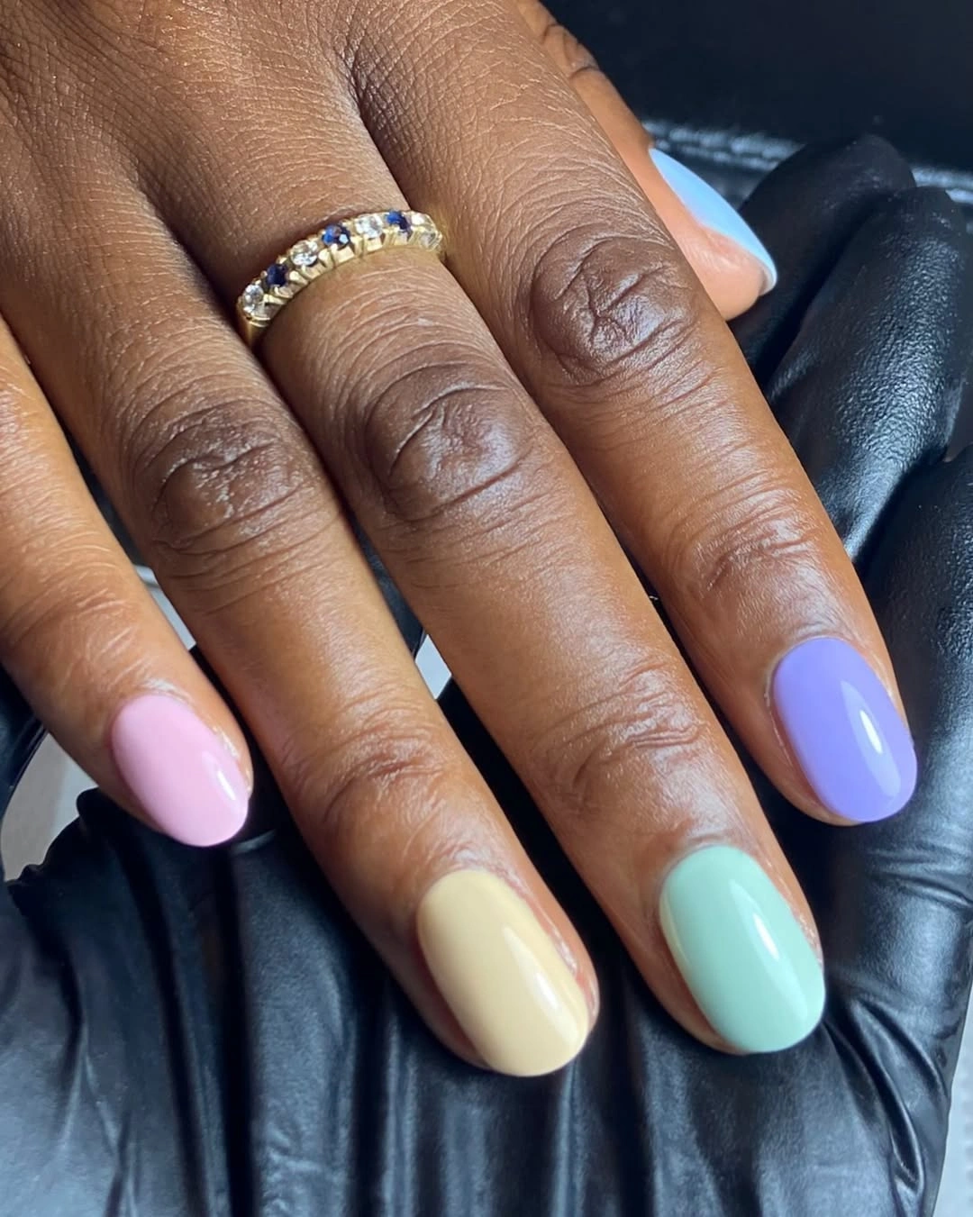 Short pastel skittle nails on dark skin