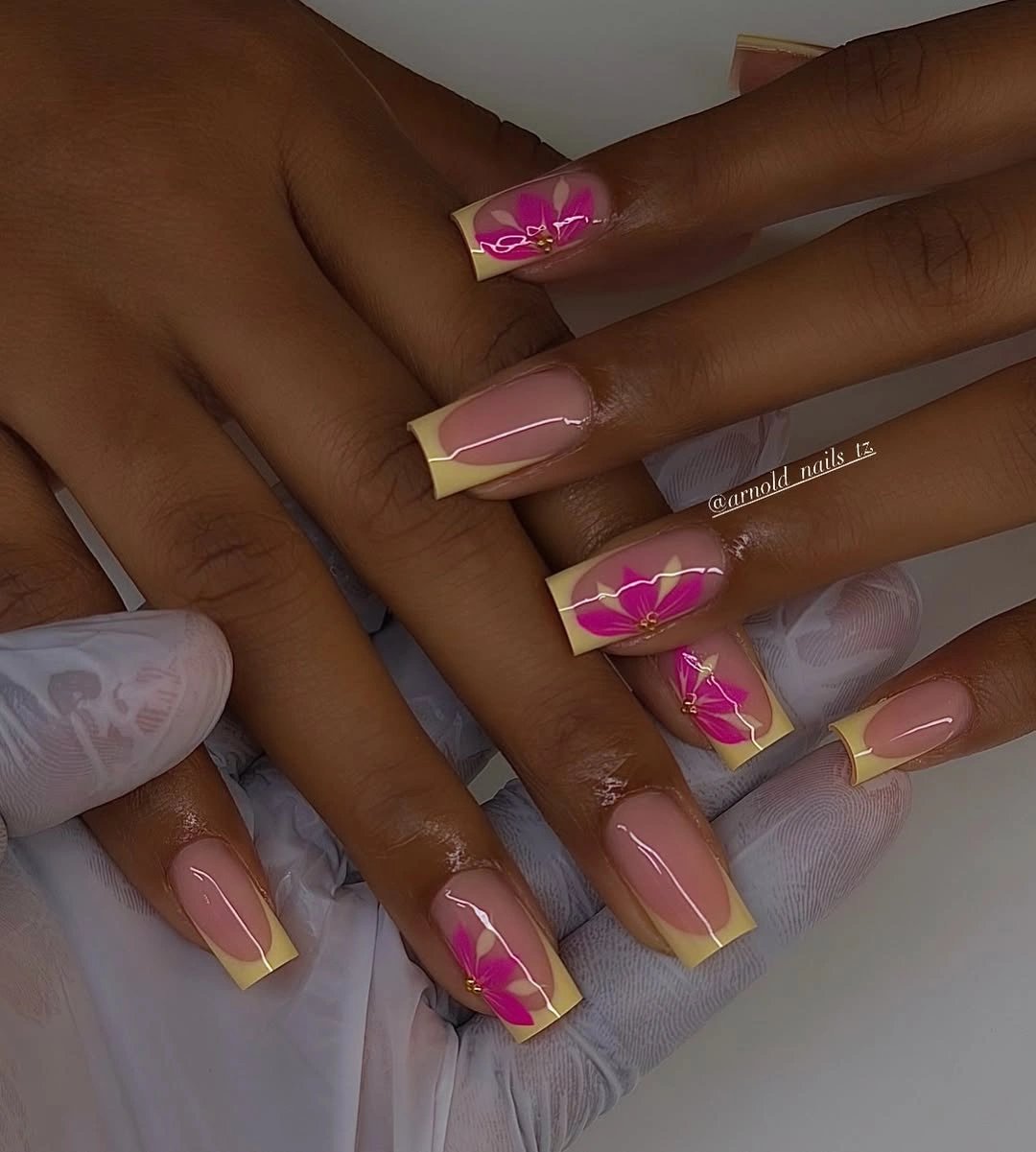 Yellow square French nails with vivid pink flowers