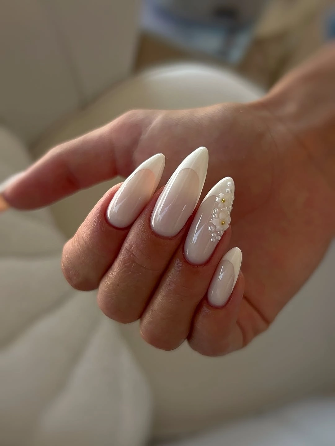 Long soft white almond nails with pale pink reflective accents