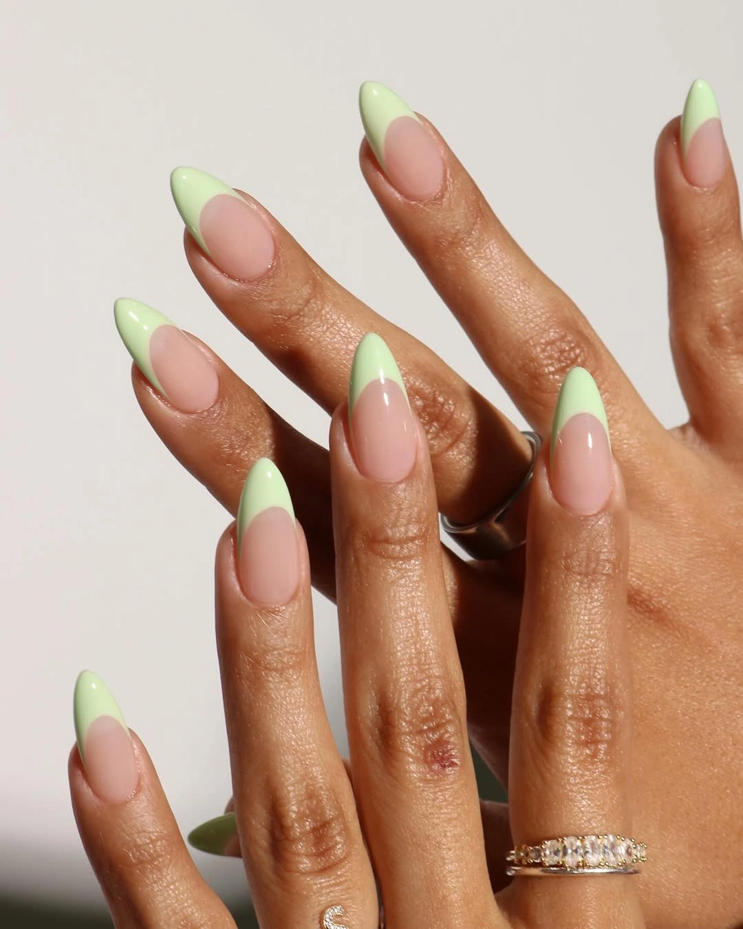 Pink almond nails with evenly spaced mint green tips