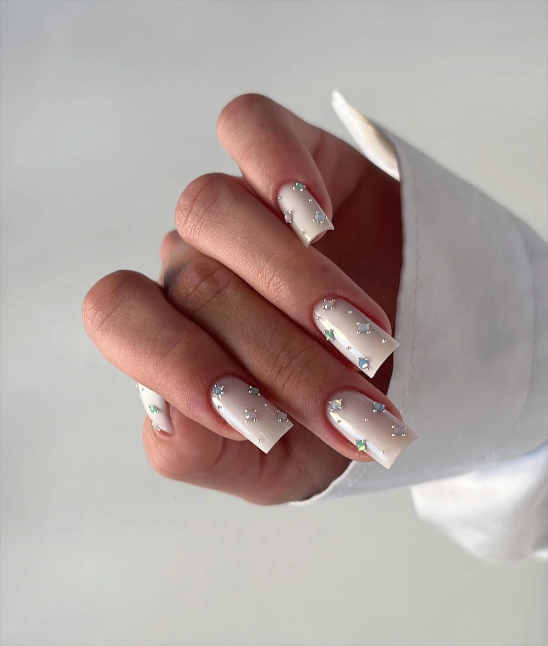 Long square white pink nails with fine silver accents