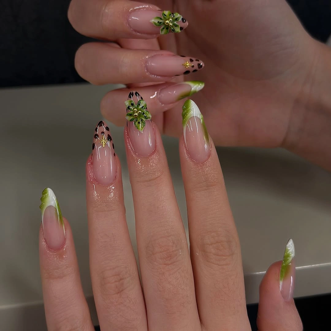 Sheer pink nails with lime tips and tiny floral accents