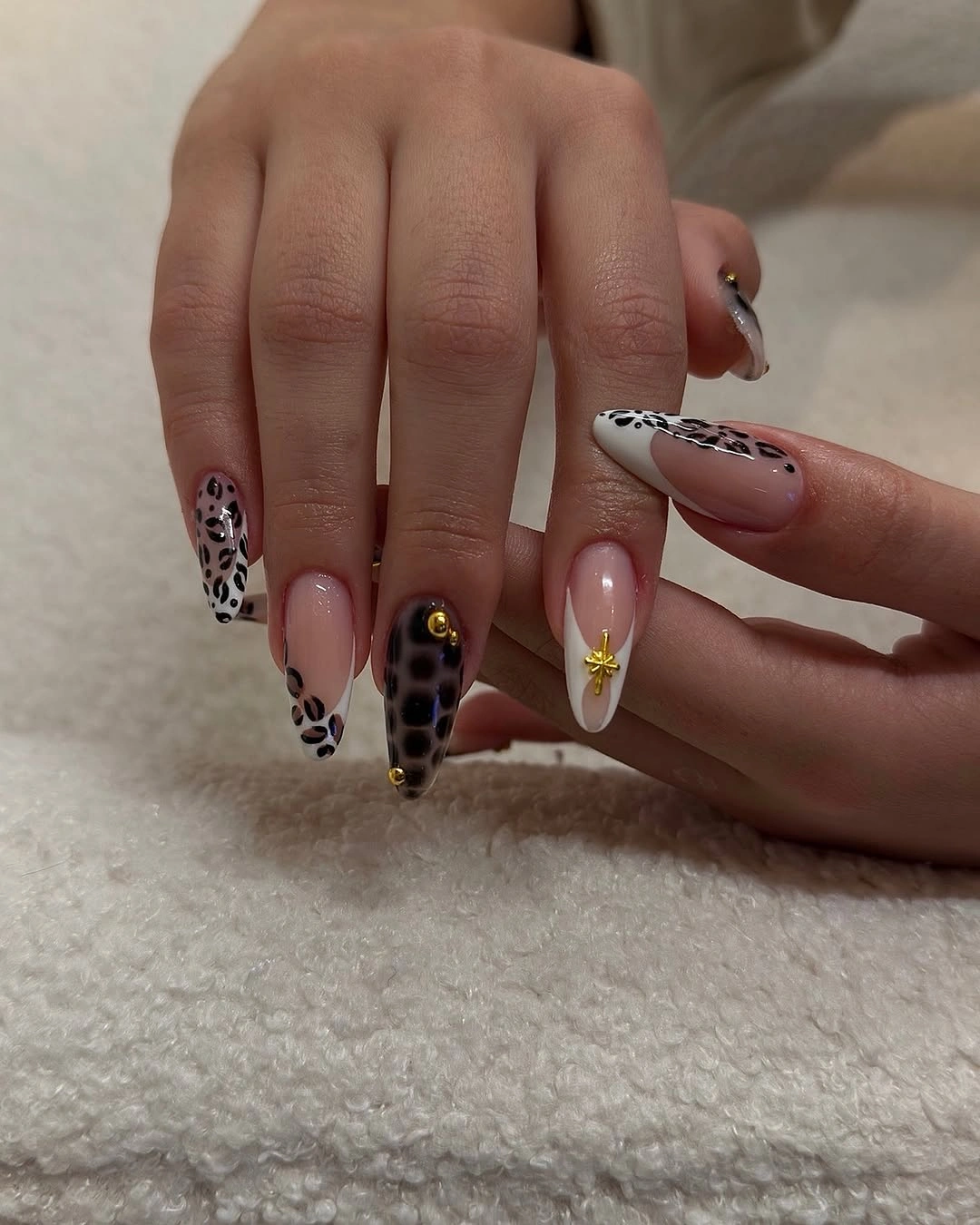 Pink almond nails with black white spotted accent details