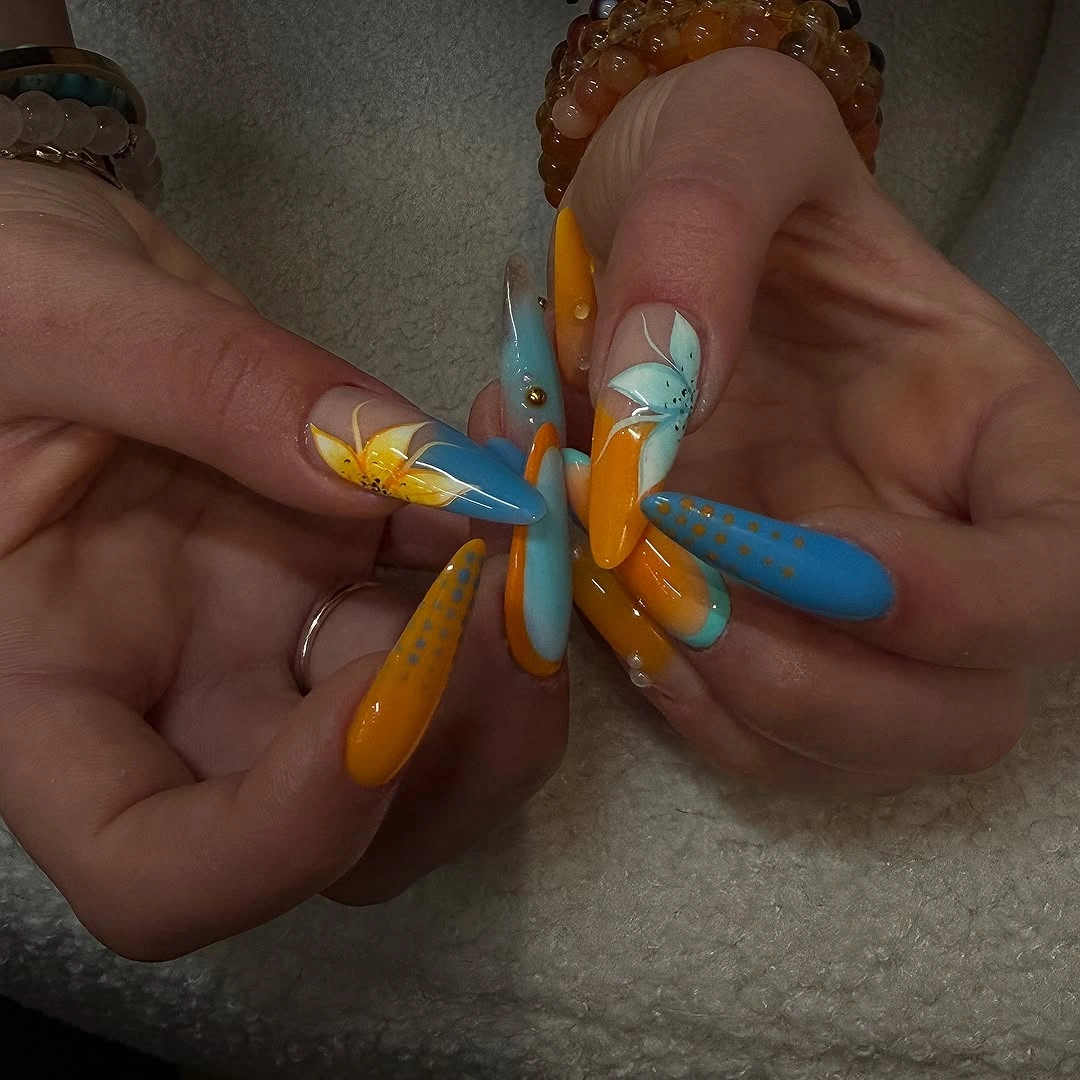 Long orange turquoise white and yellow pointed nails