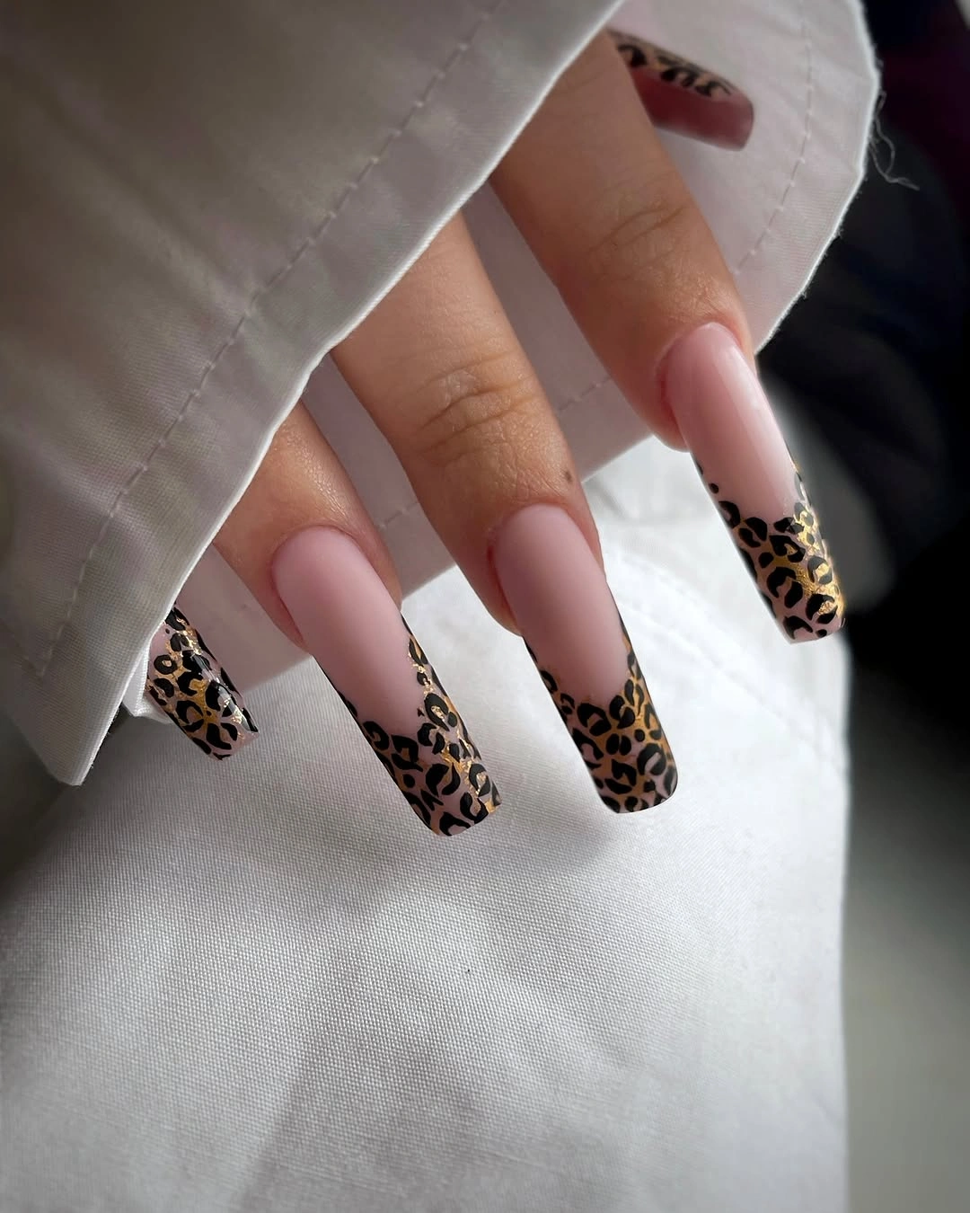 Long square pink nails with leopard French tips