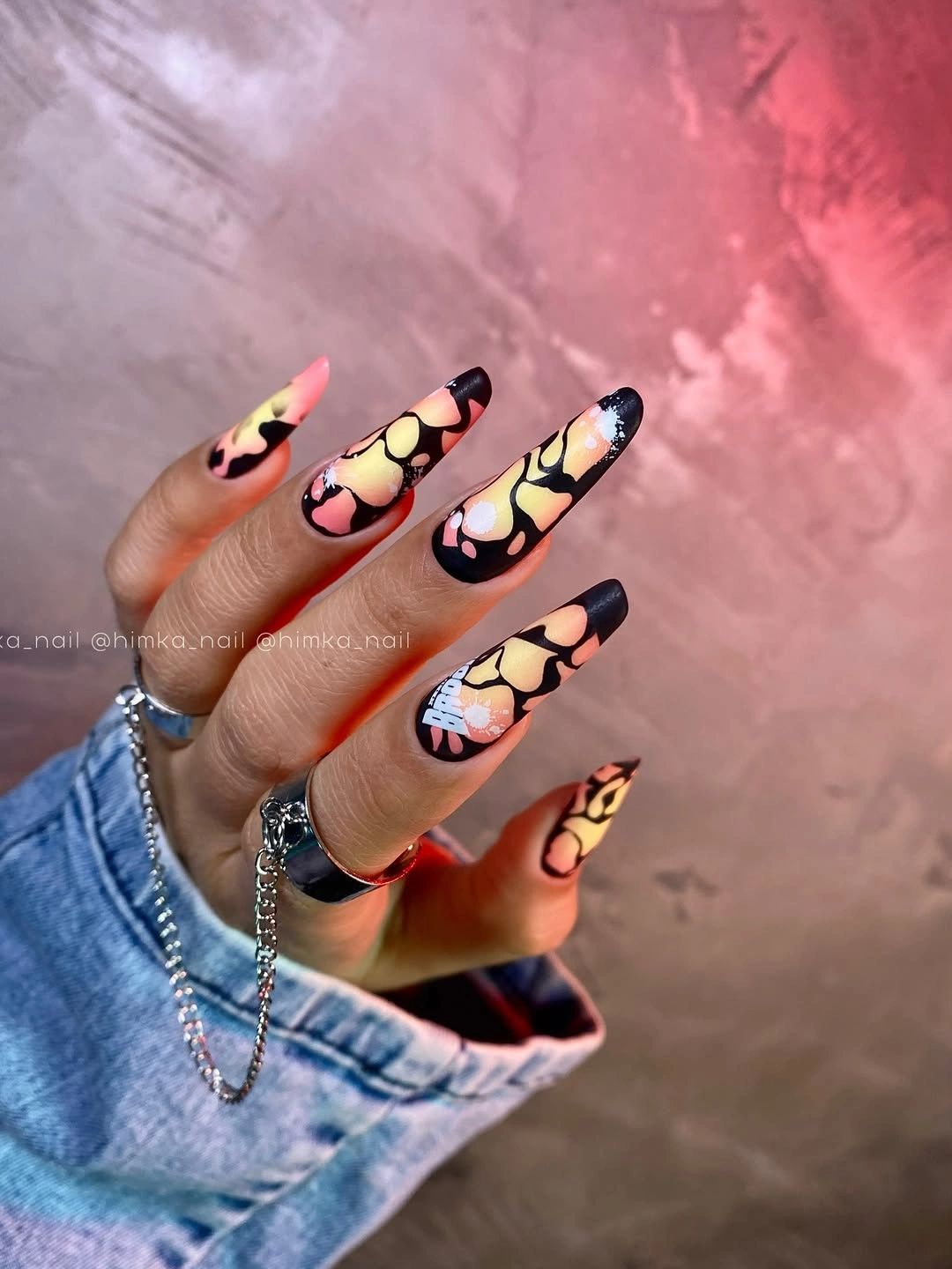 Long black nails with warm abstract color patches