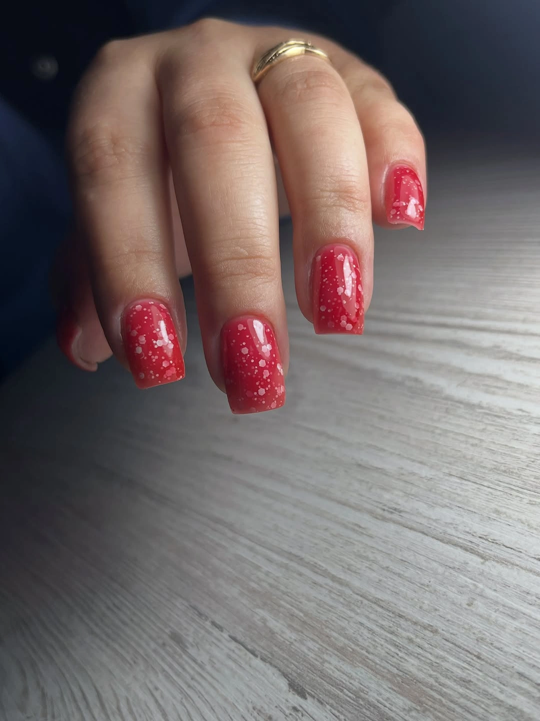 Short square red nails with pale speckled accents