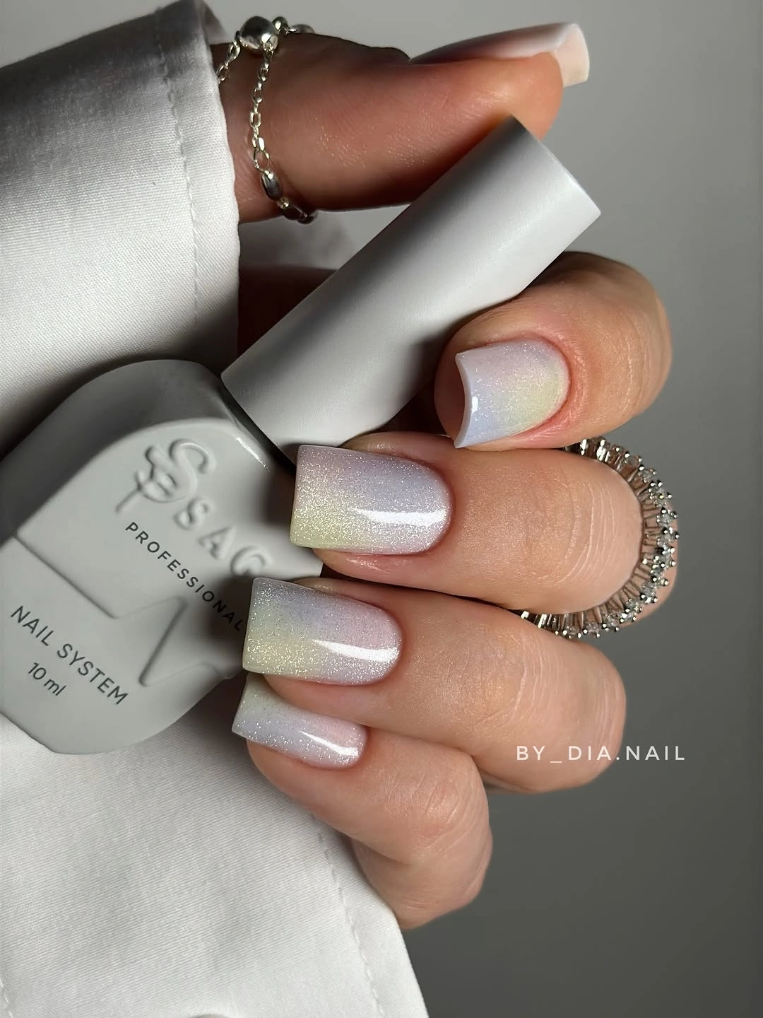 Short square pearly nails with a soft rainbow sheen