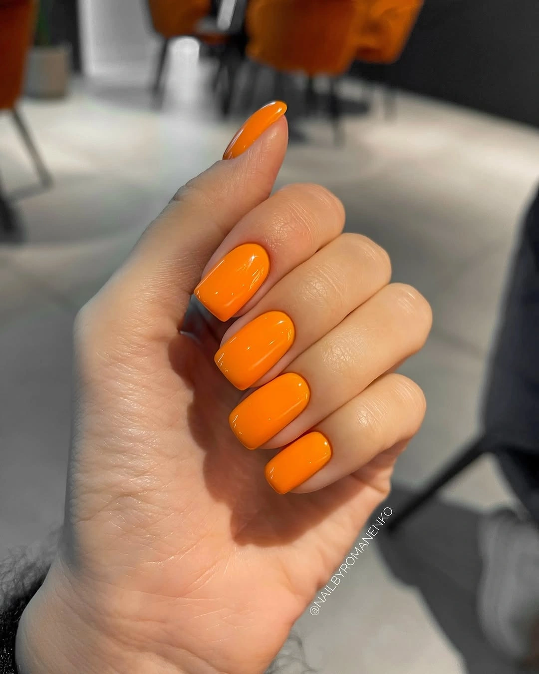 Short rounded square glossy orange nails