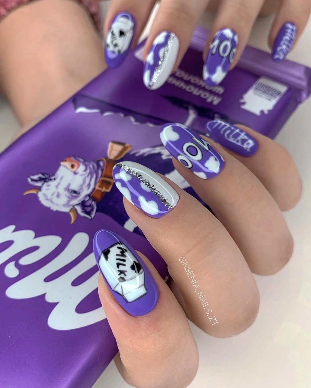 Long almond purple nails with white graphic accents