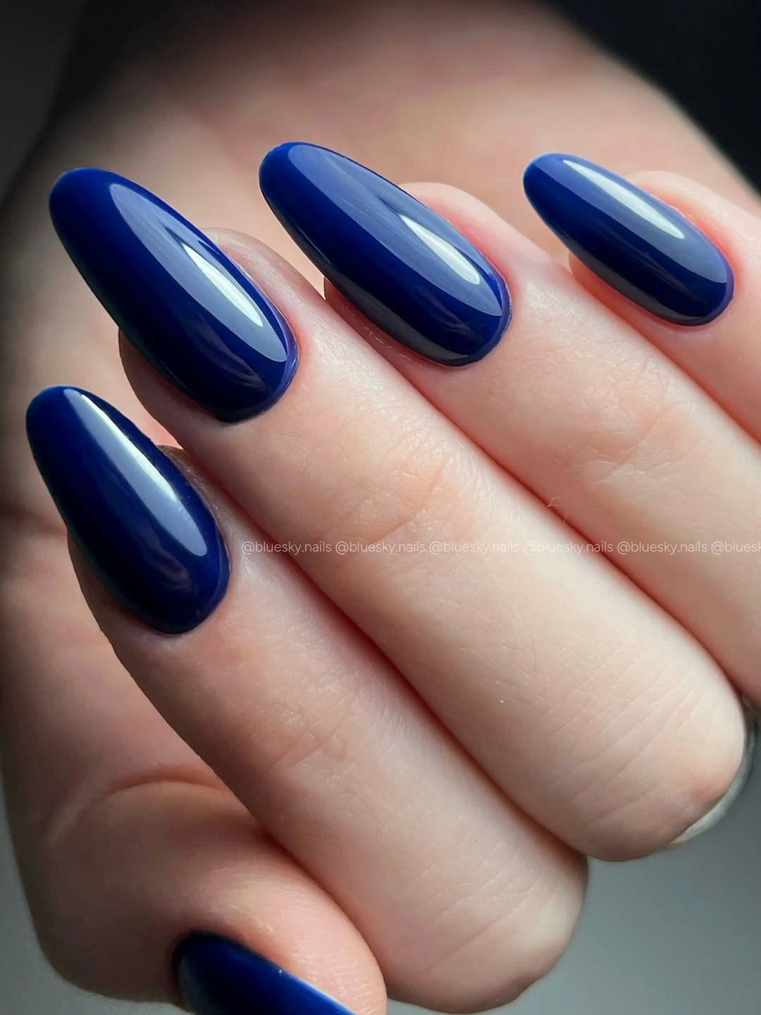 Medium almond nails with a smooth solid navy finish