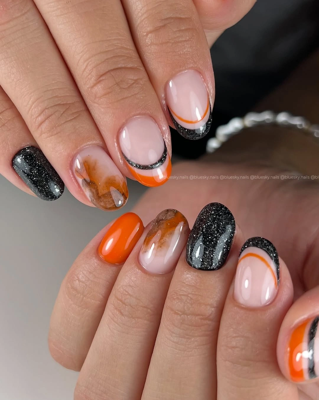 Almond nails with black orange gray and pale curved tips