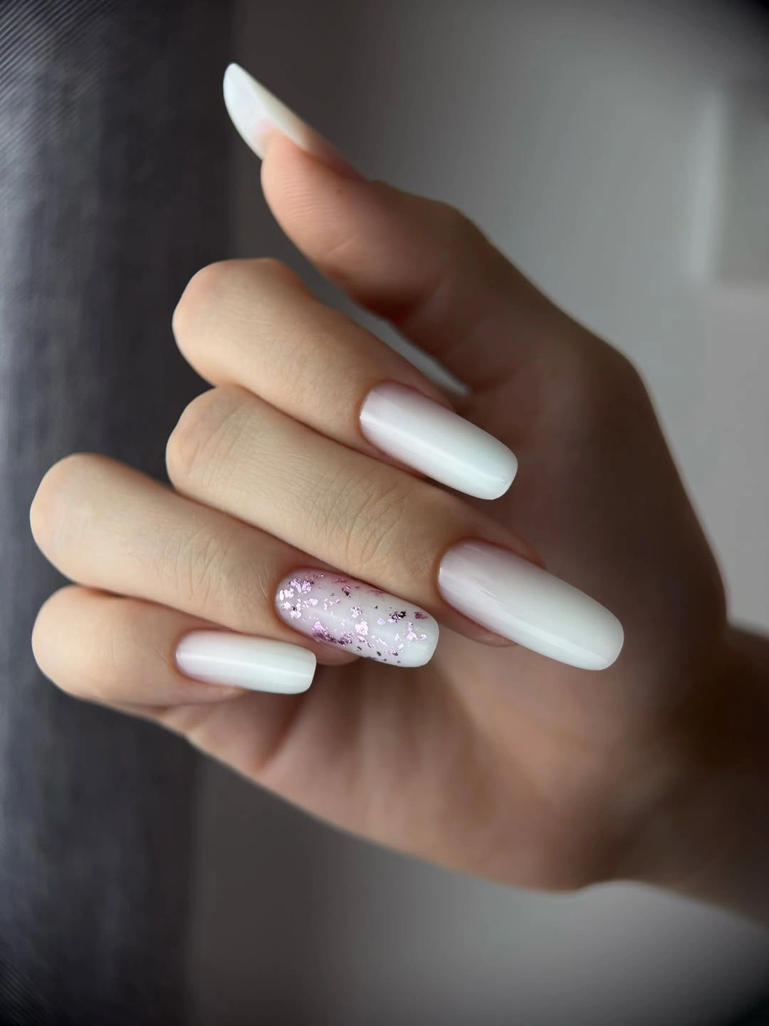 Long white almond nails with pale pink reflective accents