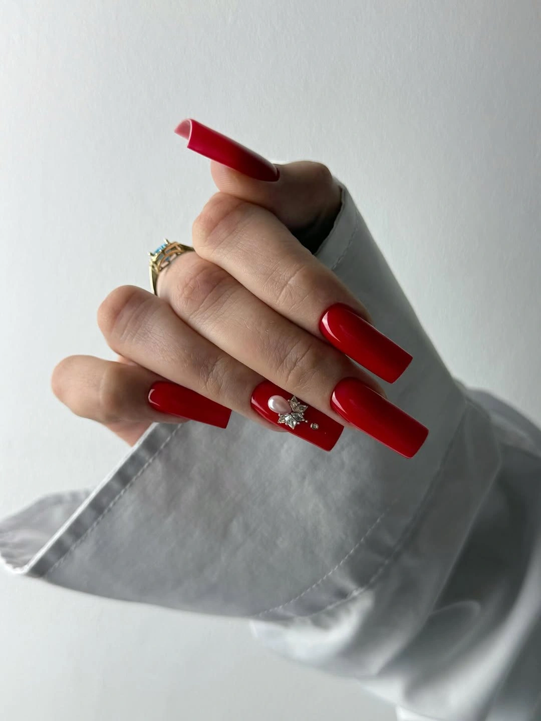 Long square red nails with white diagonal accents